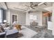 Stylish living room with gray sofa, rug, polished concrete floors, and industrial ceiling features with connecting bedroom at 115 W Peachtree Nw # 405, Atlanta, GA 30313