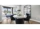 Stylish dining area with modern table setting, decorative mirror, and bright natural light flowing from the living room at 147 Park Lane Ln, Fairburn, GA 30213