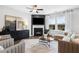 Relaxing living room features a cozy fireplace, large windows for natural light, and stylish modern furniture at 147 Park Lane Ln, Fairburn, GA 30213