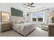 Serene main bedroom featuring a tufted headboard, modern decor, large windows, and a sitting area at 1475 Park Lane Ln, Fairburn, GA 30213