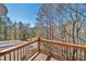 Wooden deck with railing overlooking lush backyard scenery at 3460 Mansions Pkwy, Berkeley Lake, GA 30096