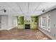 Finished basement area with a cozy fireplace, built-in shelving, and ample windows for natural light and comfort at 3460 Mansions Pkwy, Berkeley Lake, GA 30096