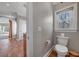 Bright bathroom with a classic toilet, window and tile flooring at 3460 Mansions Pkwy, Berkeley Lake, GA 30096