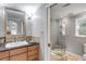 A stunning bathroom features a glass shower, granite countertop, and decorative tile accents at 3460 Mansions Pkwy, Berkeley Lake, GA 30096