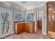 Elegant bathroom featuring custom cabinetry, a unique stained-glass door, and a glass-enclosed shower for a spa-like experience at 3460 Mansions Pkwy, Berkeley Lake, GA 30096