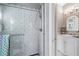 Updated bathroom boasts a glass-enclosed shower with charming tilework and vanity with an elegant mirror at 3460 Mansions Pkwy, Berkeley Lake, GA 30096