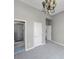 Neutral Primary bedroom with new carpet and a view to the primary bathroom at 3460 Mansions Pkwy, Berkeley Lake, GA 30096