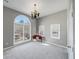 Bright bedroom with neutral color palette and large arch window at 3460 Mansions Pkwy, Berkeley Lake, GA 30096