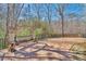 Wooden deck with a custom-built bench and views of the surrounding wooded landscape at 3460 Mansions Pkwy, Berkeley Lake, GA 30096