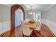 Formal dining room with hardwood floors, wainscoting, and decorative window treatment at 3460 Mansions Pkwy, Berkeley Lake, GA 30096