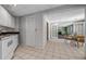 Open-concept kitchen with white cabinets and tile flooring leading to the dining area at 3460 Mansions Pkwy, Berkeley Lake, GA 30096