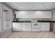 A bright kitchen features white cabinets, white appliances, and tile flooring at 3460 Mansions Pkwy, Berkeley Lake, GA 30096