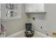 Small laundry room with tile flooring has a basket for storing items at 3460 Mansions Pkwy, Berkeley Lake, GA 30096