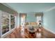 Bright living room featuring hardwood floors, neutral walls, and large windows offering views of the landscaped yard at 3460 Mansions Pkwy, Berkeley Lake, GA 30096