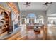 Expansive living room with fireplace, hardwood floors, and an abundance of natural light at 3460 Mansions Pkwy, Berkeley Lake, GA 30096