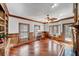 Cozy living room featuring wood trim, hardwood floors, and a bay window nook at 3460 Mansions Pkwy, Berkeley Lake, GA 30096