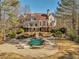 Exterior view of a home with a backyard pool and lounge area at 3460 Mansions Pkwy, Berkeley Lake, GA 30096