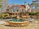 Expansive rear exterior of home overlooking swimming pool, with multiple decks and patios for entertaining in a tranquil setting at 3460 Mansions Pkwy, Berkeley Lake, GA 30096