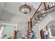 Entryway with a staircase features hardwood steps, an ornate railing, and a designer light fixture at 3460 Mansions Pkwy, Berkeley Lake, GA 30096