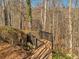 Wooded property featuring a wood walkway with iron gate accent at 3460 Mansions Pkwy, Berkeley Lake, GA 30096