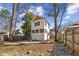 Spacious backyard features a stone patio with seating, a lush lawn, mature trees, and privacy fencing at 633 Mckoy St, Decatur, GA 30030