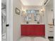 Bathroom featuring dual sinks, white countertops, a red vanity and a glass shower at 633 Mckoy St, Decatur, GA 30030