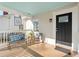 Cozy front porch with seating, a blue ceiling, and a decorative glass-paneled front door at 633 Mckoy St, Decatur, GA 30030