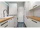 Bright laundry room features wood countertops, a stackable washer and dryer and blue floors at 633 Mckoy St, Decatur, GA 30030