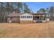 Large backyard with brick house, sunroom, covered patio, and expansive lawn at 6890 Cedar Mountain Rd, Douglasville, GA 30134