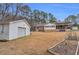 Spacious backyard featuring a detached garage, a house with sunroom and a covered patio at 6890 Cedar Mountain Rd, Douglasville, GA 30134