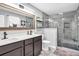 Modern bathroom with double vanity, sleek fixtures, and glass-enclosed shower at 6890 Cedar Mountain Rd, Douglasville, GA 30134