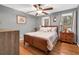 Cozy bedroom with hardwood floors, a ceiling fan, and bright windows at 6890 Cedar Mountain Rd, Douglasville, GA 30134