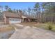 Brick home showing the driveway and attached garage with covered porch at 6890 Cedar Mountain Rd, Douglasville, GA 30134