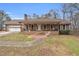 Charming brick home with a covered front porch and attached garage, showcasing curb appeal at 6890 Cedar Mountain Rd, Douglasville, GA 30134