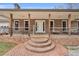 Covered front porch with brick columns and steps leading up to the front door at 6890 Cedar Mountain Rd, Douglasville, GA 30134