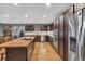 Bright kitchen with stainless steel appliances, dark cabinets, and a butcher block island at 6890 Cedar Mountain Rd, Douglasville, GA 30134