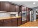 Kitchen showcasing stainless steel appliances, dark cabinets, and butcher block countertop at 6890 Cedar Mountain Rd, Douglasville, GA 30134