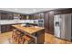 Modern kitchen boasts dark cabinetry, stainless appliances, and a butcher block island at 6890 Cedar Mountain Rd, Douglasville, GA 30134