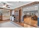 Charming living room featuring exposed brick and hardwood floors with a view into the dining area at 6890 Cedar Mountain Rd, Douglasville, GA 30134