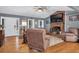 Living room showcases a brick fireplace, wood floors, and views to the outside at 6890 Cedar Mountain Rd, Douglasville, GA 30134