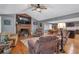 Cozy living room featuring a brick fireplace, hardwood floors, and an open layout at 6890 Cedar Mountain Rd, Douglasville, GA 30134