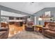 Open-concept living room with wood floors flowing into a modern kitchen with seating at 6890 Cedar Mountain Rd, Douglasville, GA 30134