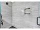 Elegant shower with gray tile, a built-in niche, and modern fixtures at 6890 Cedar Mountain Rd, Douglasville, GA 30134