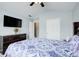 Bedroom featuring a flat screen television, patterned bedspread, and ceiling fan at 1832 Millstone Mnr, Conyers, GA 30013