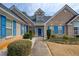 Inviting front entrance with blue shutters, lush landscaping, and a brick facade at 1832 Millstone Mnr, Conyers, GA 30013