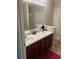 Bathroom featuring double sinks, a large mirror, and dark wood cabinets for ample storage at 3954 Riverside Pkwy, Decatur, GA 30034