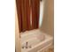 Soaking tub with brown textured curtains, perfect for relaxing after a long day at 3954 Riverside Pkwy, Decatur, GA 30034