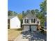 Inviting two-story home featuring a two-car garage, neutral siding, and lush landscaping at 3954 Riverside Pkwy, Decatur, GA 30034