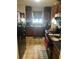 Cozy kitchen with brown cabinets, black appliances, and floral accents at 3954 Riverside Pkwy, Decatur, GA 30034