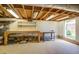 Unfinished basement with exposed ceiling, workbench, and a window for natural light at 411 Burke Cir, Mcdonough, GA 30253